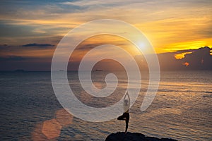 Meditation girl on the sea during sunset. Yoga silhouette.