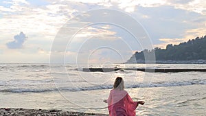 Meditation near the sea and doing yoga on a beach at sunrise