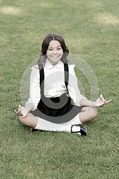 Meditation practice. Good vibes. Peaceful meditation. Learn meditation techniques. Girl school pupil sit on lawn. Tune