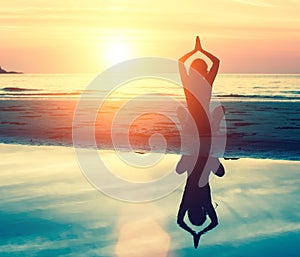 Meditation, serenity and yoga practicing at sunset. Nature.
