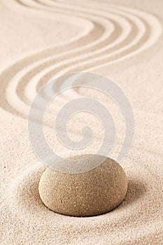 Meditation stone on sand background