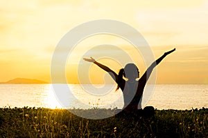 Meditation yoga lifestyle woman silhouette on the Sea sunset, relax vital.