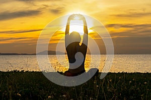 Meditation yoga lifestyle woman silhouette on the Sea sunset, relax vital.