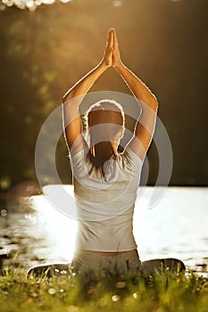 Meditation yoga woman meditating at bank river and relaxing in yoga pose.