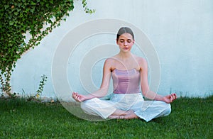 Meditation yoga woman in spring park. Woman stretching. Young girl practicing yoga, doing fit exercise, working out on