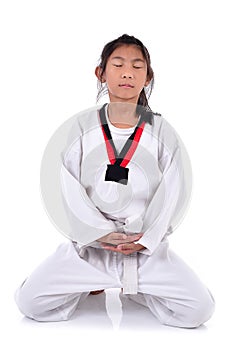 Meditative Asian girl in the Taekwondo school