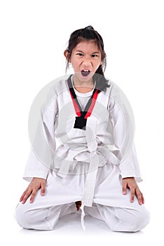 Meditative Asian girl in the Taekwondo school, isolated on white.