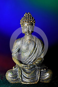 Meditative Buddha image against dark blue background