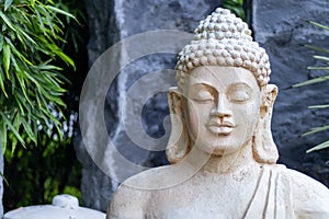 Meditative pose of a buddha statue face closeup. Peace concept