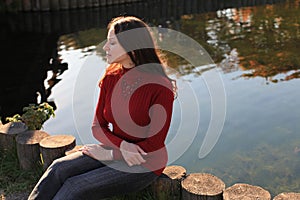 Meditative woman by lake photo