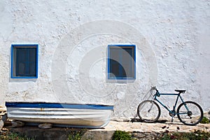 Mediterranean boat bicycle and white wall in white