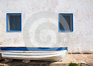 Mediterranean boat and whitewashed wall in white and blue