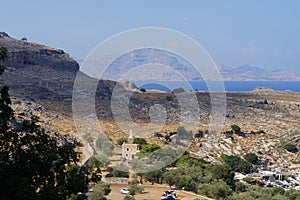 Mediterranean coast with the monument to Ioannis Zigdis in Lindos. Rhodes, Dodecanese, Greece