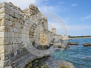Mediterranean coastline. The picturesque ruins of the southern wall of the ancient city of Korikos