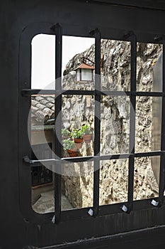 Mediterranean courtyard door with flowerpots and lantern