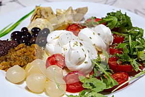 Mediterranean cuisine salad with mozzarella olives artichokes onions