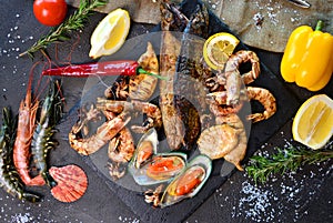 Mediterranean dinner with grilled shrimps, mussels, squids and fish.