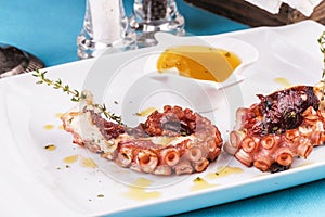 Mediterranean dish fried octopus tentacles with bolzimik sauce and rosemary