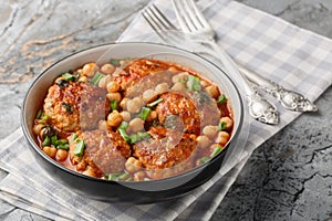 Mediterranean food Lamb meatballs served with chickpeas, tomato and green onions close-up in a bowl. Horizontal