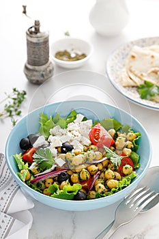 Mediterranean Greek and chickpea salad with fresh vegetables and feta cheese