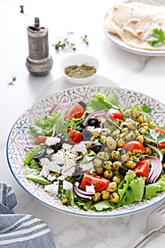 Mediterranean Greek and chickpea salad with fresh vegetables and feta cheese
