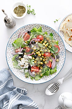 Mediterranean Greek and chickpea salad with fresh vegetables and feta cheese