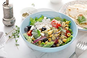 Mediterranean Greek and chickpea salad with fresh vegetables and feta cheese