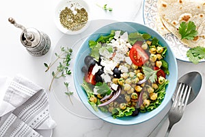 Mediterranean Greek and chickpea salad with fresh vegetables and feta cheese