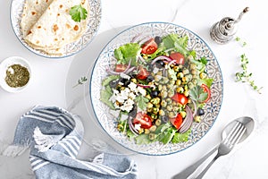 Mediterranean Greek and chickpea salad with fresh vegetables and feta cheese