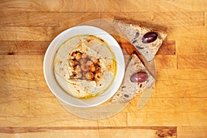 Mediterranean Homemade hummus with chickpeas, herbs and freshly baked baguette from Above