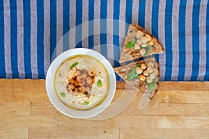 Mediterranean Homemade hummus with chickpeas, herbs and freshly baked baguette from Above