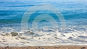 Mediterranean landscape in Antalya, Turkey. Blue sea, waves and pebble sandy beach