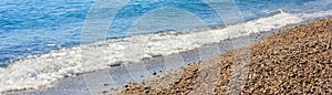 Mediterranean landscape in Antalya, Turkey. Blue sea, waves and pebble sandy beach