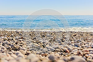 Mediterranean landscape in Antalya, Turkey. Blue sea, waves and pebble sandy beach