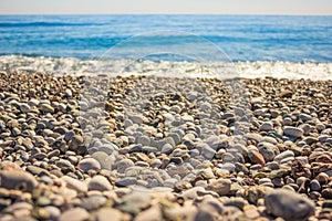 Mediterranean landscape in Antalya, Turkey. Blue sea, waves and pebble sandy beach