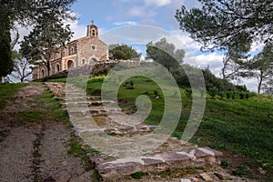 Mediterranean little chapel over a hill in the countryside. Menorca, Spain photo