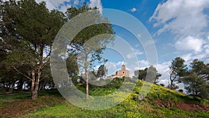 Mediterranean little chapel over a hill in the countryside. Menorca, Spain photo