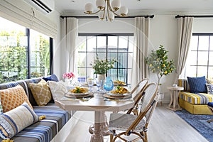 Mediterranean living room interior with bright yellow and blue sofa and pillow.