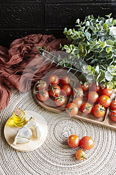 Mediterranean products: cherry tomatoes, extra virgin olive oil and garlic