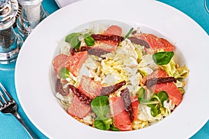 Mediterranean salad. Cabbage, tomatoes, smoked seeds, olives, olives, basil and rosemary, seasoned with olive oil and balsamic sau