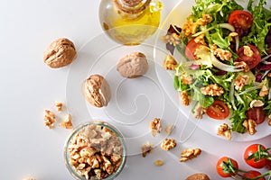 Mediterranean salad with walnuts in plate with olive oil top