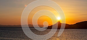 Mediterranean sea. Beautiful sunset and a lighthouse at Kea island, Greece.