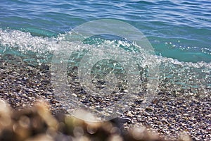 Mediterranean sea waves flooded the beach. Selective focus