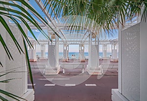 Mediterranean Sea and white colonnade on Promenade des Anglais at sunset in Nice France photo