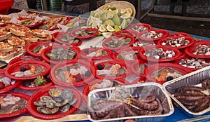 Mediterranean seafood street trade in Sicily. Dishes with fish, mussels, shrimps and octopus