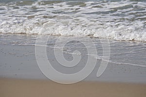 Mediterranean seashore in winter. Calm sea waves on sandy beach