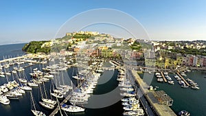 Mediterranean seaside town aerial shot, boats docked in port, summer vacation