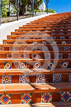 Mediterranean style ceramic tiles lining an upward spiral staircase
