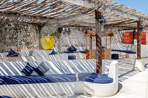 Mediterranean style interior in white and blue colors with rustic twig ceiling