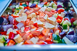 Mediterranean vegetables in a silver baking tray ready for oven roasting